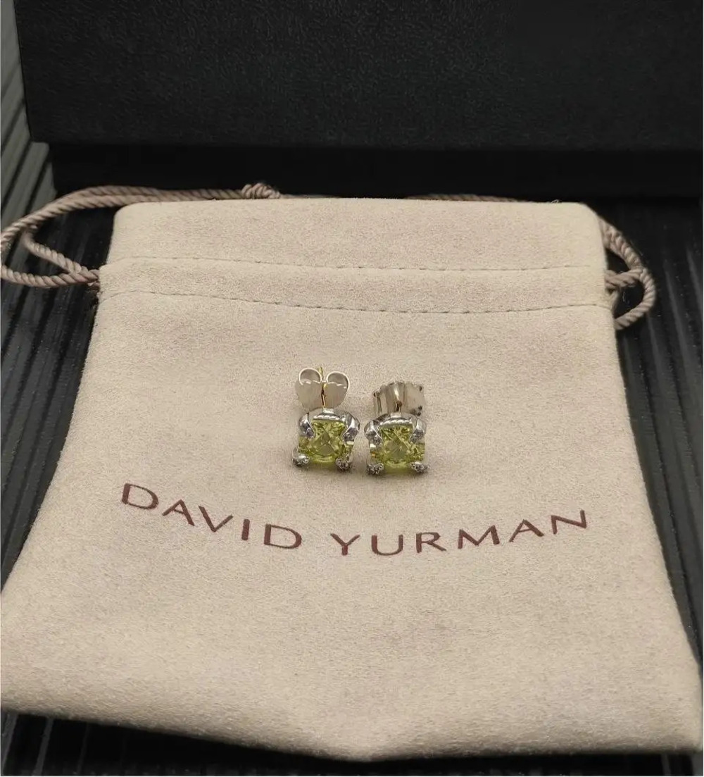 David Yurman four-prong earrings with a main stone and green diamond